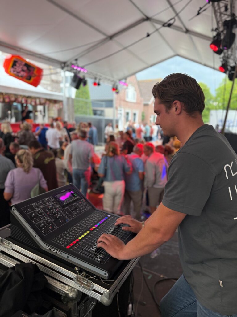 Geluidstechnicus van Muller Productions achter de mengtafel tijdens een evenement