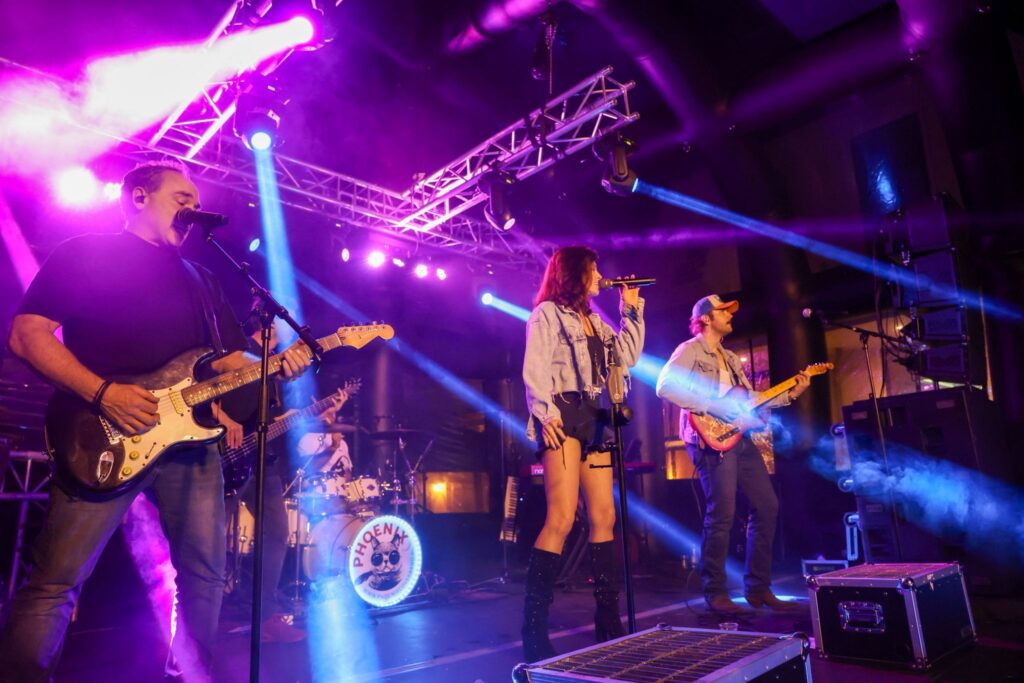Phoenix Coverband tijdens een optreden met podiumlicht en live bandtechniek